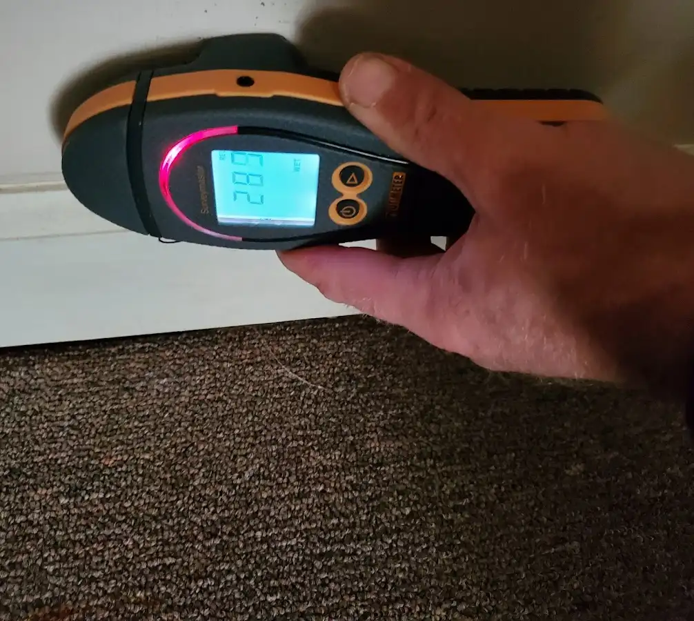 Moisture detection at baseboard during Storm Damage Restoration in Englewood